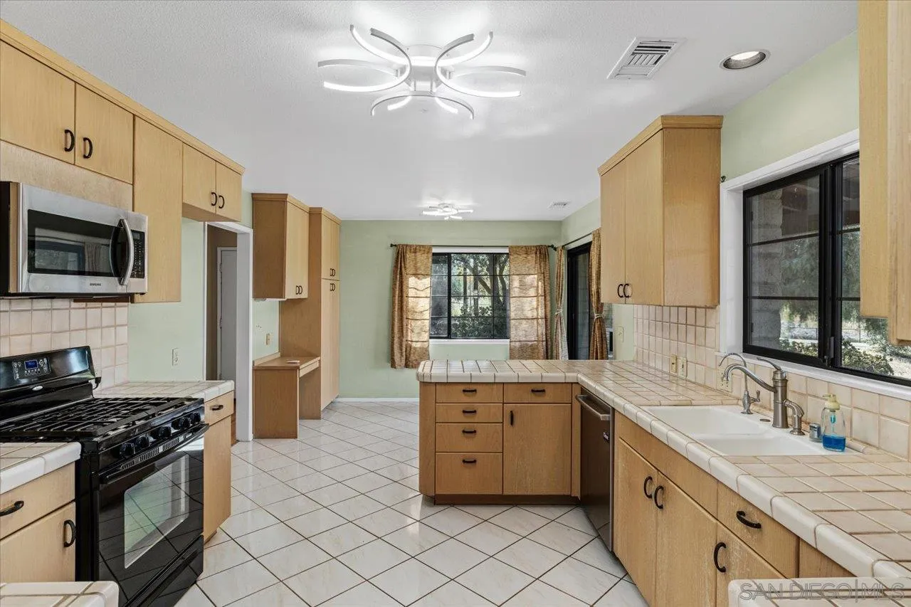 29956 Miller Road Valley Center, CA 92082 - Photo 4 of 45 a large kitchen with stainless steel appliances granite countertop a stove and a sink