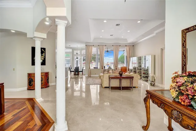 a large white kitchen with a large counter top sink and refrigerator