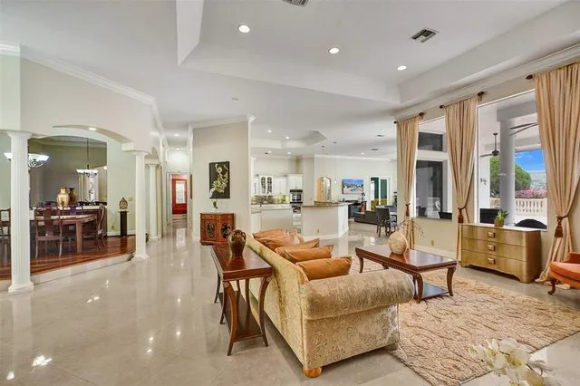 a living room with furniture and kitchen view