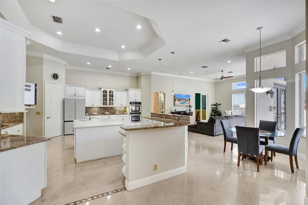 8426 Sawpine Road Delray Beach, FL 33446 - Photo 30 of 91 a kitchen with cabinets and chairs