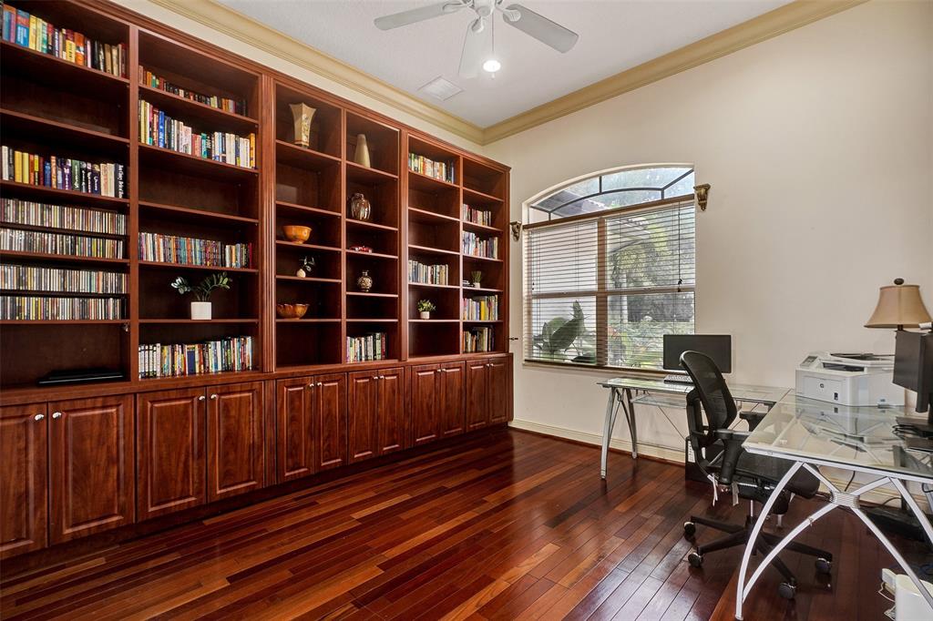 8426 Sawpine Road Delray Beach, FL 33446 - Photo 47 of 91 a view of a workspace with furniture and a bookshelf