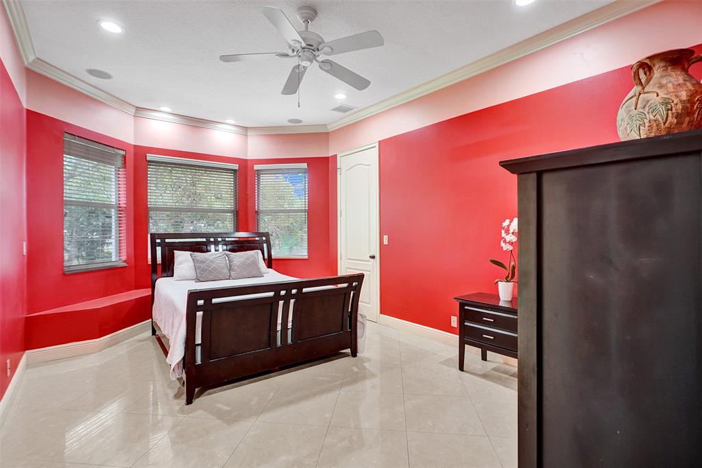 8426 Sawpine Road Delray Beach, FL 33446 - Photo 58 of 91 a living room with furniture a flat screen tv and a large window