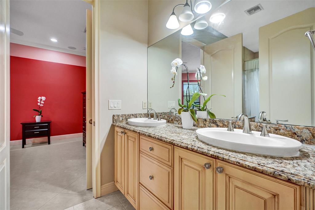 8426 Sawpine Road Delray Beach, FL 33446 - Photo 63 of 91 a en suite bathroom with a granite countertop double vanity sink and a mirror