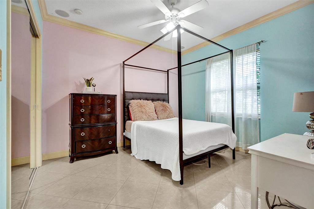 8426 Sawpine Road Delray Beach, FL 33446 - Photo 67 of 91 a bedroom with a bed and a ceiling fan