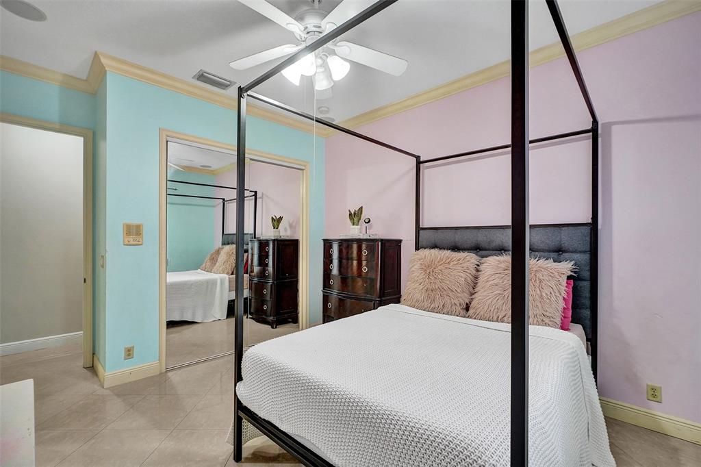 8426 Sawpine Road Delray Beach, FL 33446 - Photo 68 of 91 a bed room with a bed and a chandelier