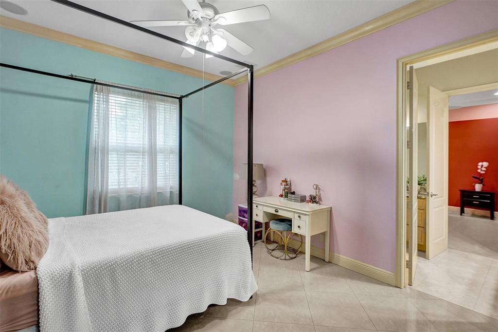 8426 Sawpine Road Delray Beach, FL 33446 - Photo 70 of 91 a bedroom with a bed and a chandelier