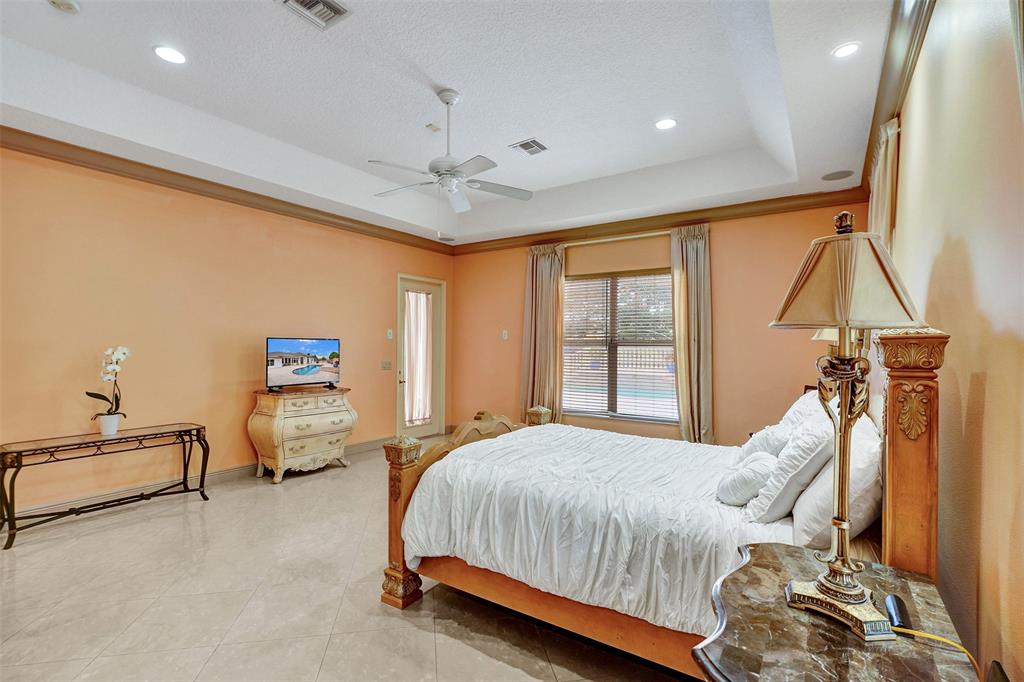 8426 Sawpine Road Delray Beach, FL 33446 - Photo 75 of 91 a bedroom with a bed and wooden floor