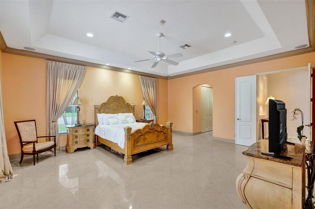8426 Sawpine Road Delray Beach, FL 33446 - Photo 76 of 91 a living room with furniture a flat screen tv and a large window
