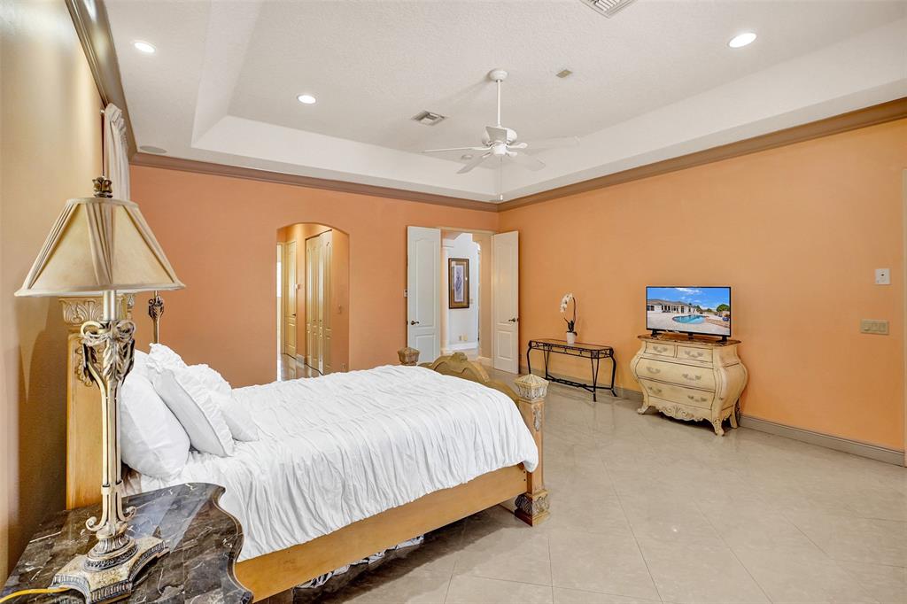 8426 Sawpine Road Delray Beach, FL 33446 - Photo 79 of 91 a bedroom with a bed and a flat tv screen on dresser