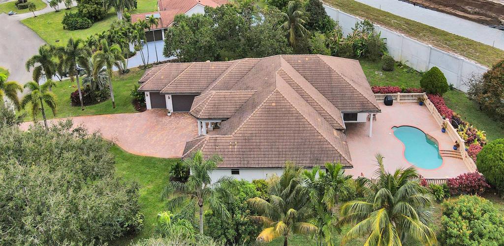 8426 Sawpine Road Delray Beach, FL 33446 - Photo 8 of 91 an aerial view of a house with yard and swimming pool