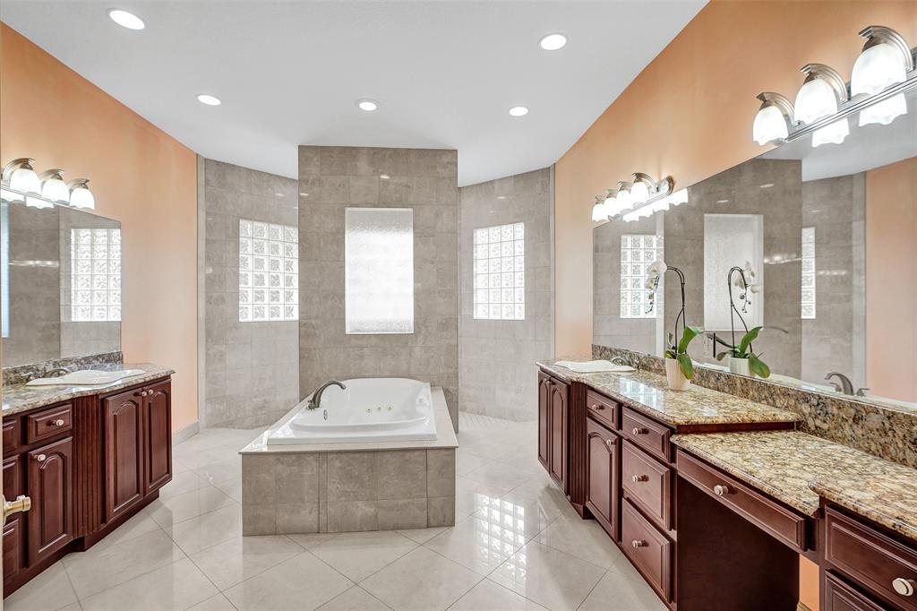 8426 Sawpine Road Delray Beach, FL 33446 - Photo 83 of 91 a spacious bathroom with a granite countertop double vanity sink large mirror and bathtub