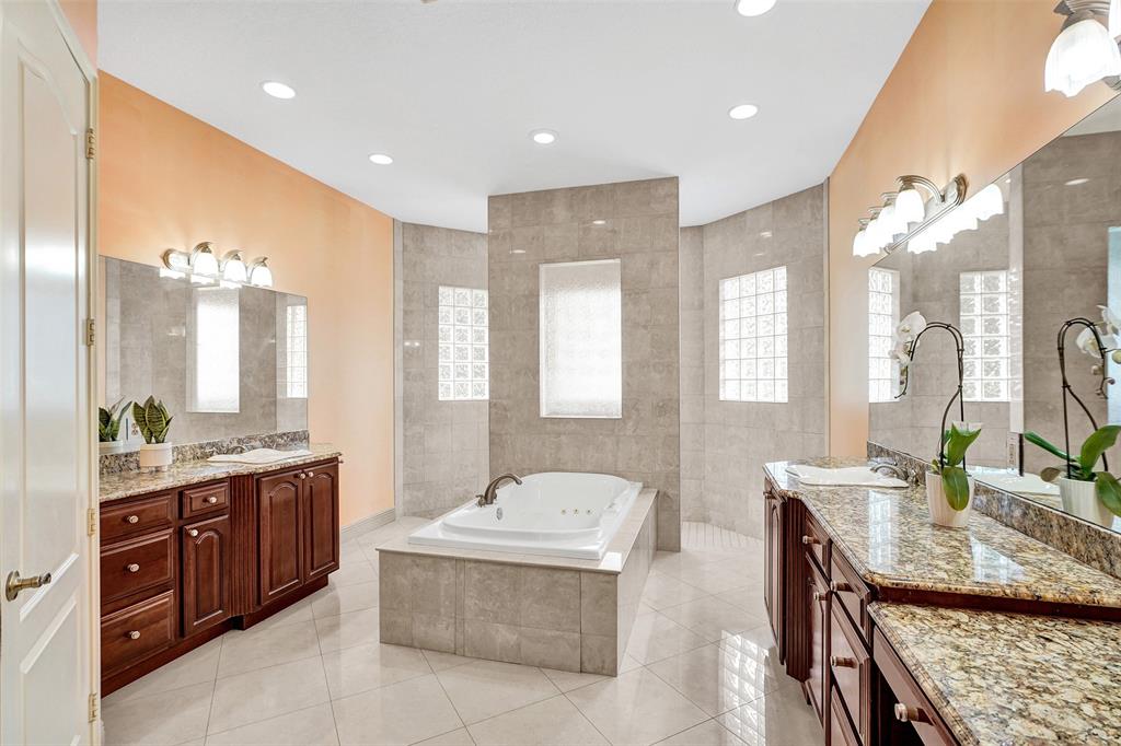 8426 Sawpine Road Delray Beach, FL 33446 - Photo 84 of 91 a spacious bathroom with a granite countertop double vanity sink a mirror and a bathtub