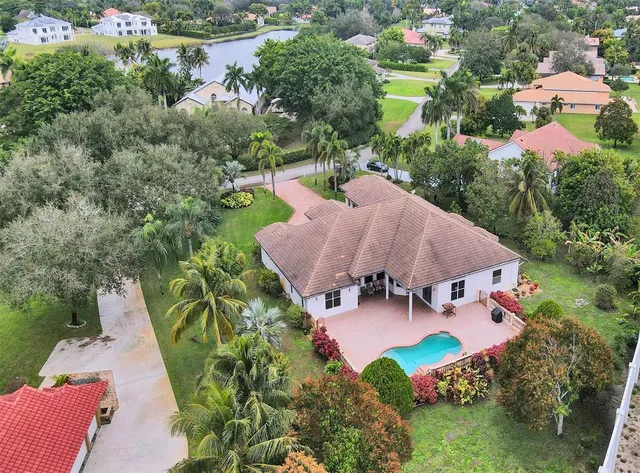 an aerial view of a house with yard swimming pool and outdoor seating