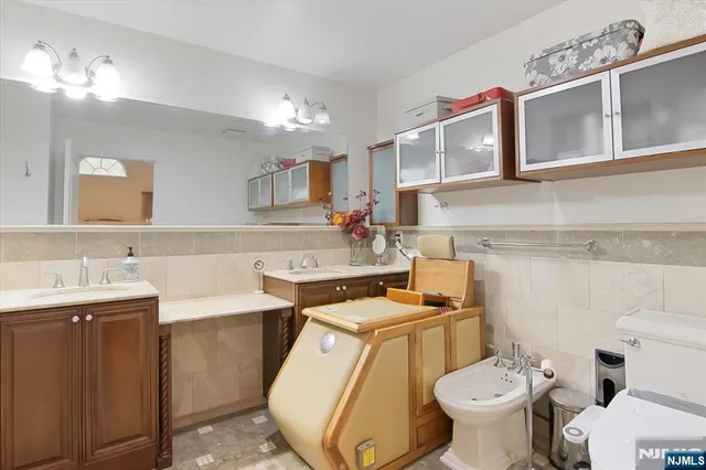 a bathroom with a sink toilet vanity and mirror
