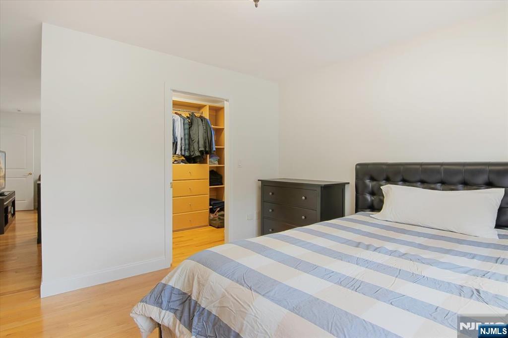 85 Harvey Avenue Paramus, NJ 07652 - Photo 23 of 32 a bedroom with a bed and wooden floor