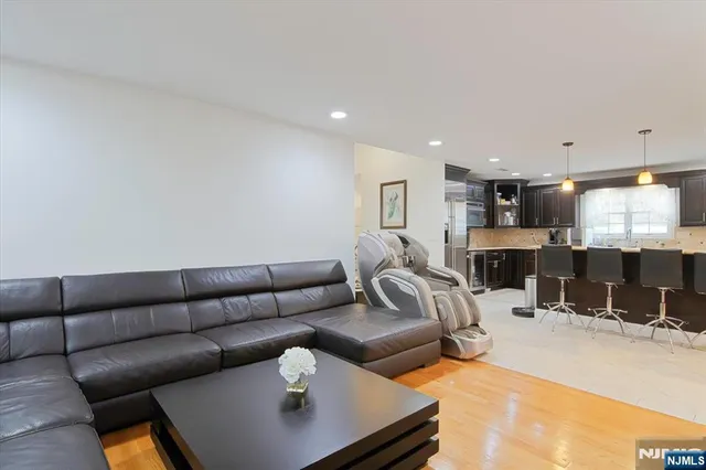 a living room with furniture and kitchen view