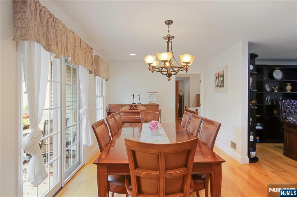 85 Harvey Avenue Paramus, NJ 07652 - Photo 10 of 32 a view of a dining room with furniture wooden floor and chandelier