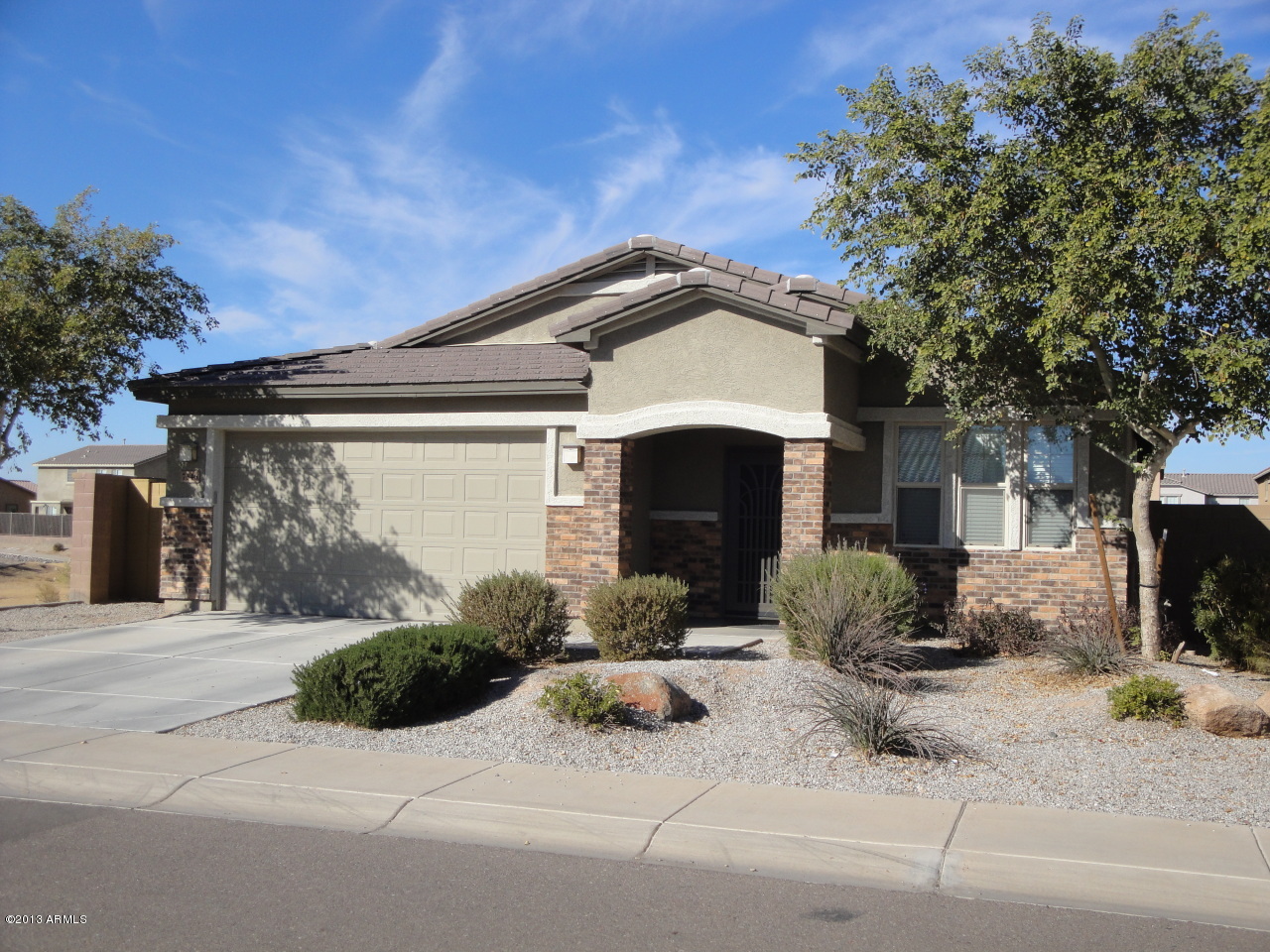 7346 West Carter Road Laveen, AZ 85339 - Photo 1 of 42 a front view of a house with a yard and garage