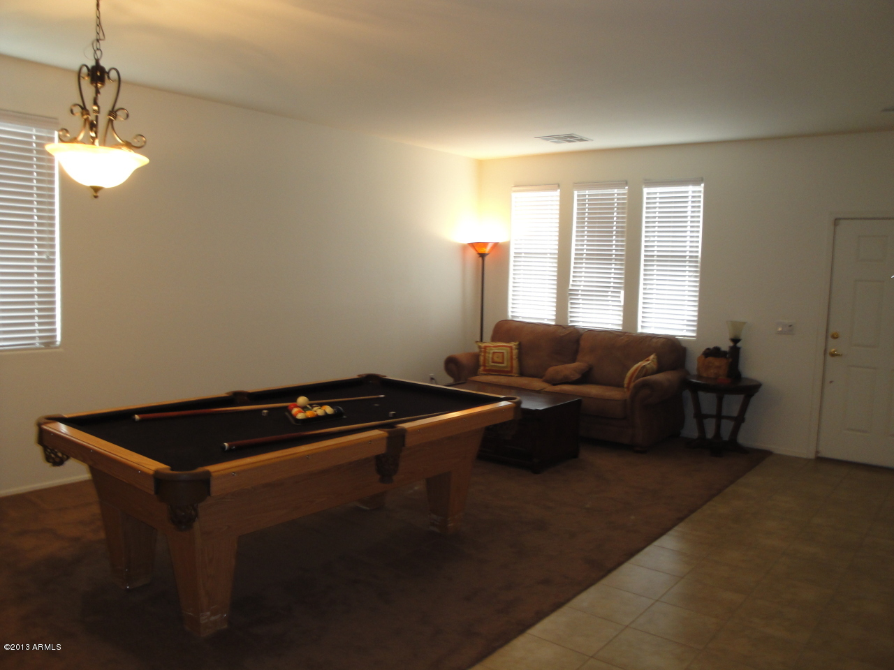 7346 West Carter Road Laveen, AZ 85339 - Photo 6 of 42 a living room with furniture a window and a chandelier