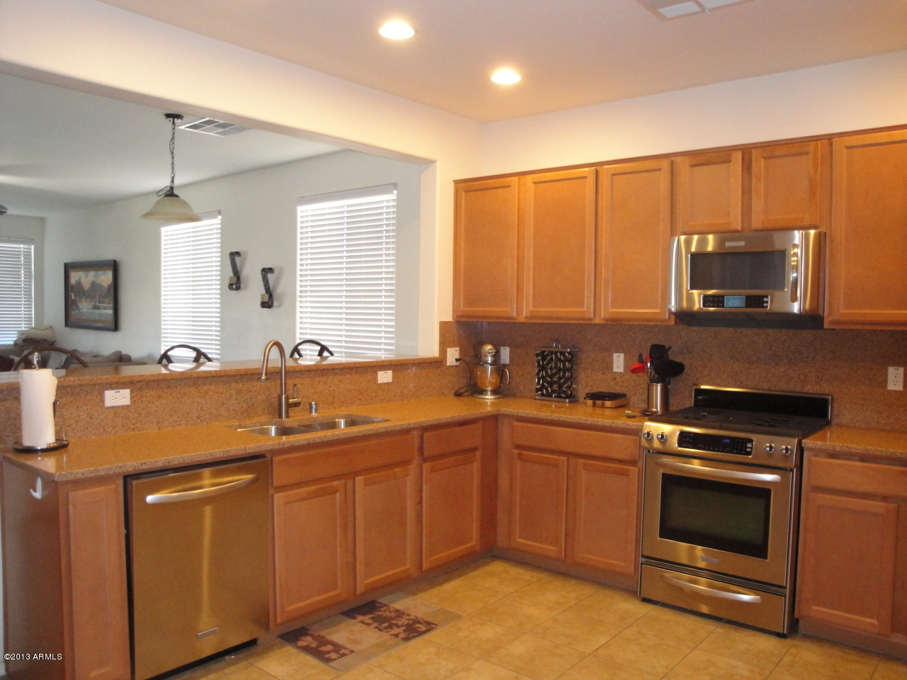 7346 West Carter Road Laveen, AZ 85339 - Photo 7 of 42 a kitchen with stainless steel appliances a sink stove and microwave
