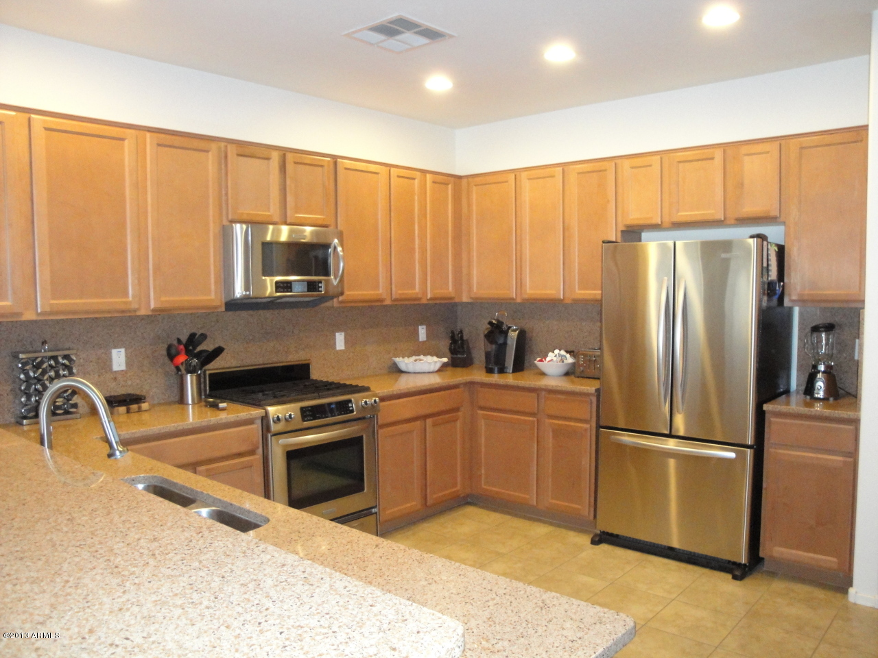 7346 West Carter Road Laveen, AZ 85339 - Photo 8 of 42 a kitchen with stainless steel appliances granite countertop a refrigerator a sink a stove a microwave and island