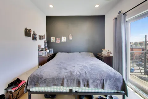 a bed sitting in a bedroom next to a window