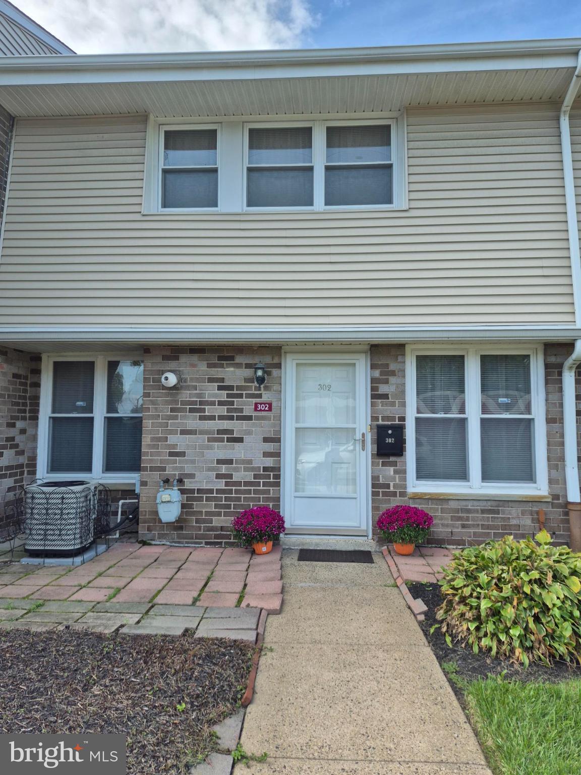 3850 Woodhaven Road, Unit 302 Philadelphia, PA 19154 - Photo 10 of 12 Charming entryway with vibrant blooms.