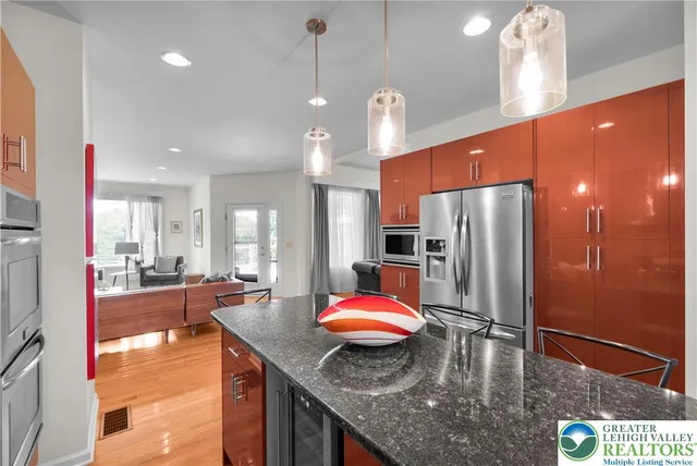 a kitchen with stainless steel appliances granite countertop a stove and a sink