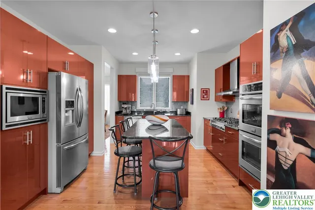 a living room with furniture kitchen view and a large window