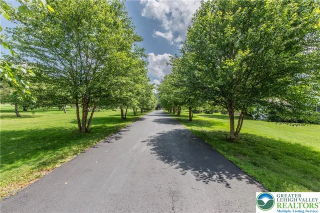 a aerial view of a house with a yard and trees