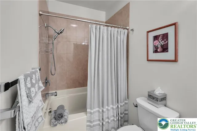 a bedroom with a bed and a flat tv screen