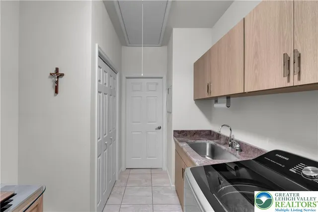 an aerial view of residential house with outdoor space and trees all around