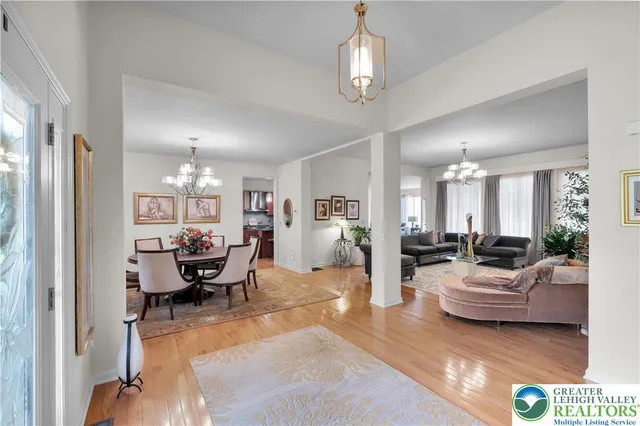 a living room with furniture a fireplace and a chandelier