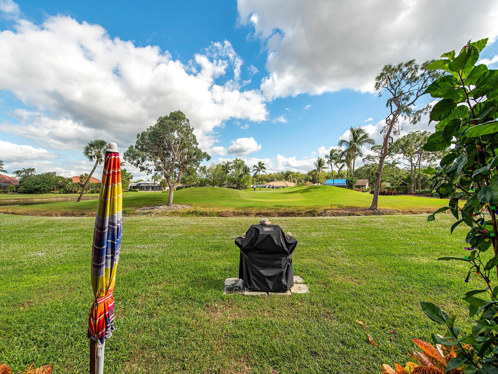 205 Deerwood Circle Naples, FL 34113 - Photo 12 of 12 a view of a golf course with a lake view