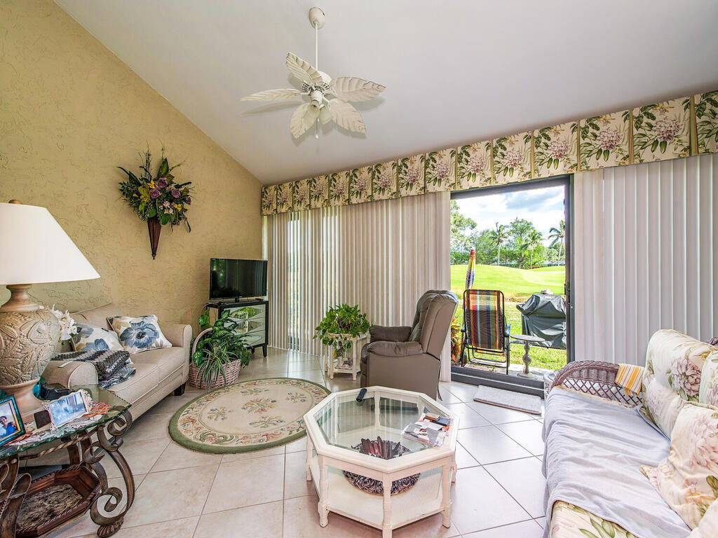 205 Deerwood Circle Naples, FL 34113 - Photo 2 of 12 a living room with furniture and a large window