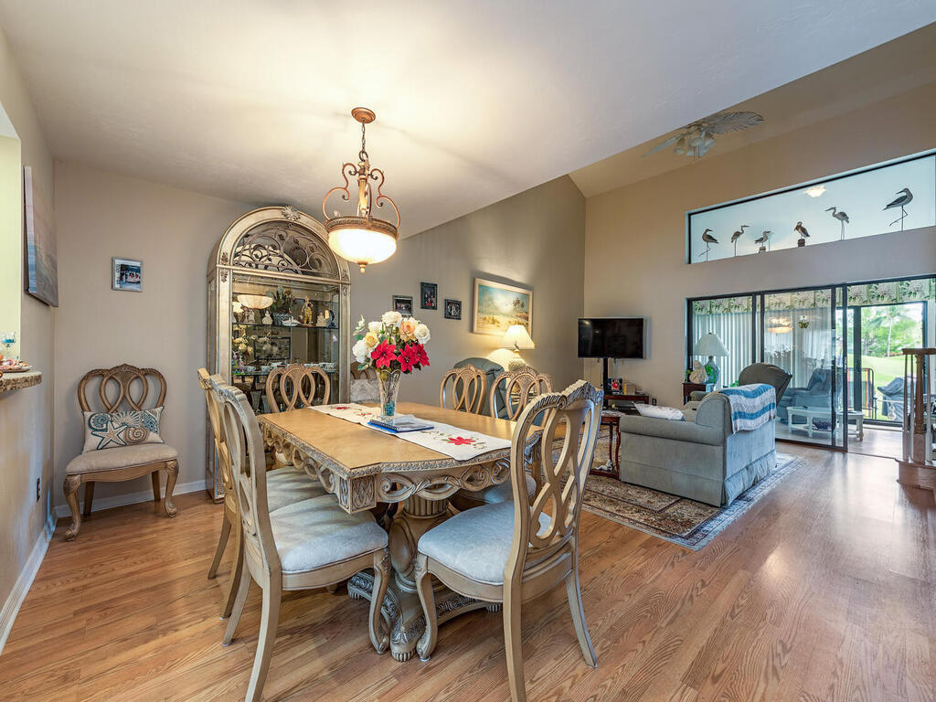 205 Deerwood Circle Naples, FL 34113 - Photo 3 of 12 a view of a dining room with furniture window and wooden floor