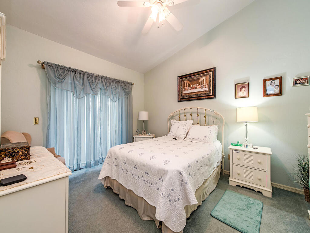205 Deerwood Circle Naples, FL 34113 - Photo 7 of 12 a bedroom with a bed and a table