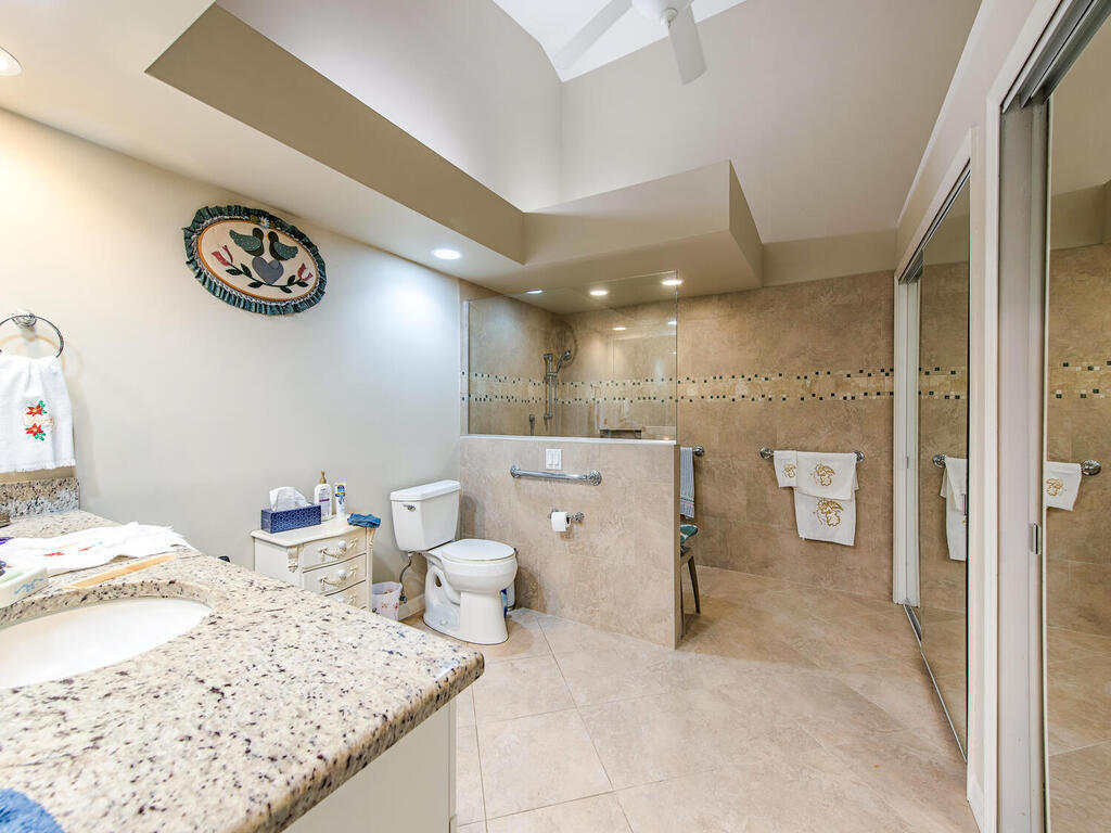 205 Deerwood Circle Naples, FL 34113 - Photo 8 of 12 a bathroom with a sink and a toilet