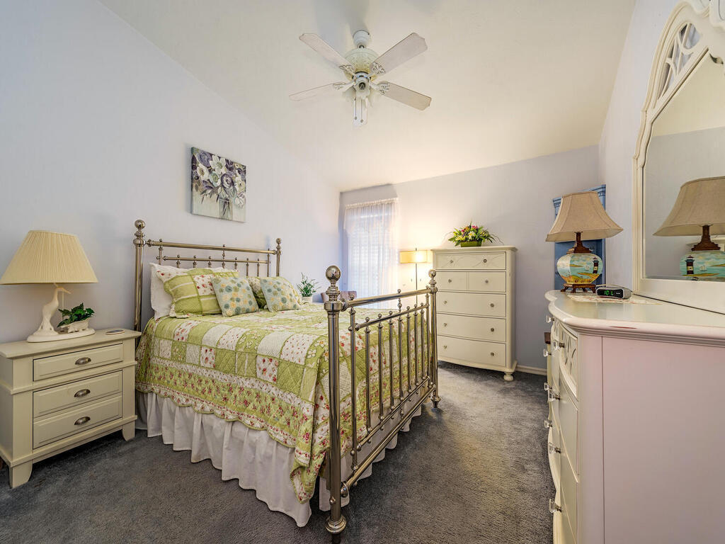 205 Deerwood Circle Naples, FL 34113 - Photo 9 of 12 a bedroom with a bed and a dresser