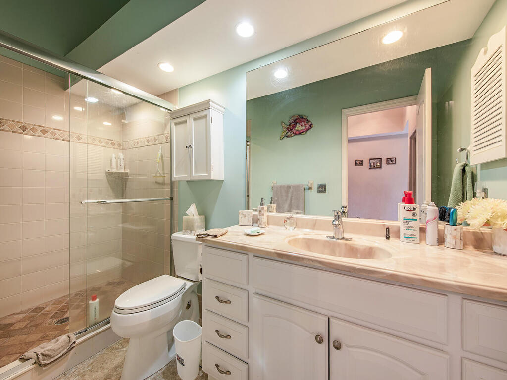 205 Deerwood Circle Naples, FL 34113 - Photo 10 of 12 a bathroom with a toilet sink and shower