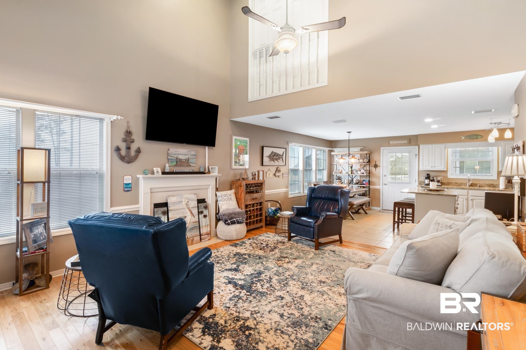 328 Windmill Ridge Road Gulf Shores, AL 36542 - Photo 4 of 47 Living room with light hardwood / wood-style flooring, a high ceiling, ceiling fan, and sink