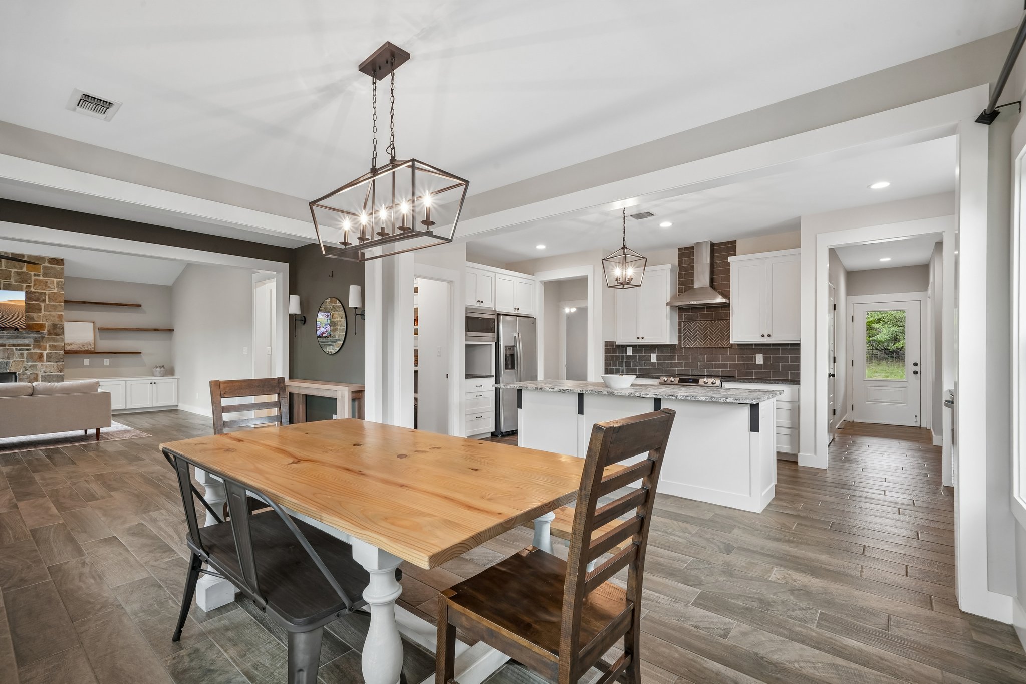 190 Magnolia Meadow Spring Branch, TX 78070 - Photo 5 of 29 An open-concept layout unites the kitchen and dining area, featuring a large island for casual meals and entertaining.