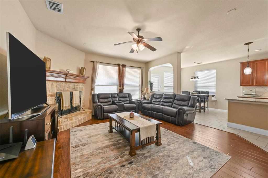 14815 Frisco Ranch Drive Little Elm, TX 75068 - Photo 13 of 40 a living room with furniture a rug and a flat screen tv