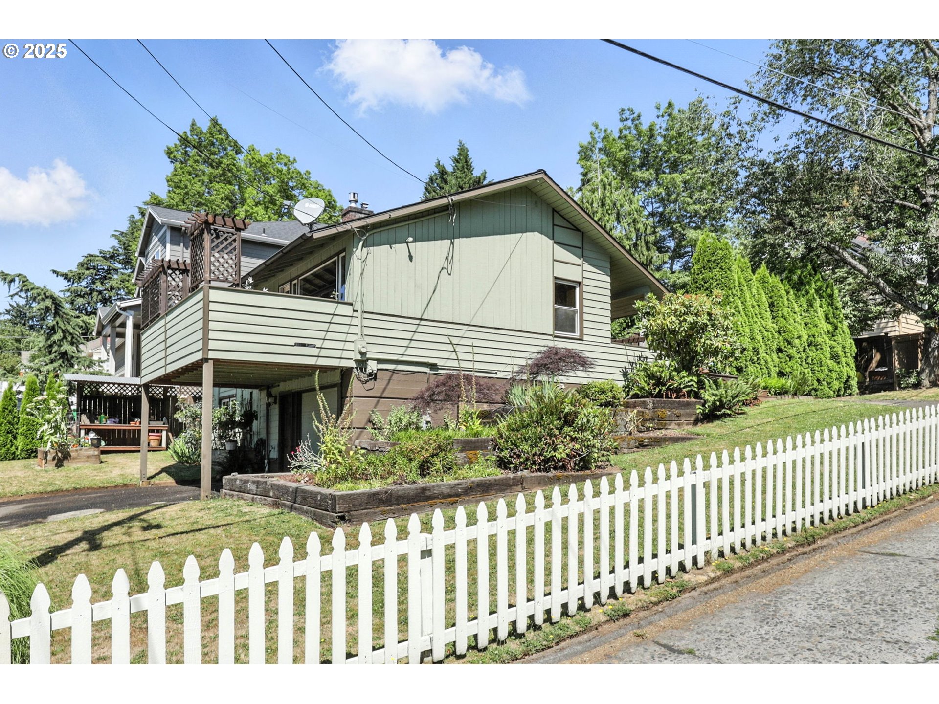 7149 Southwest 3rd Avenue Portland, OR 97219 - Photo 2 of 42 a front view of a house with a garden