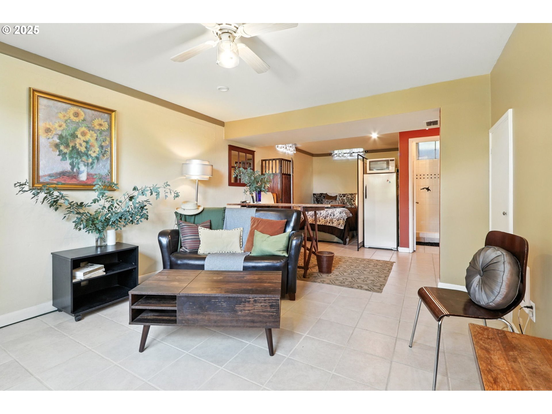 7149 Southwest 3rd Avenue Portland, OR 97219 - Photo 23 of 42 a living room with furniture a dining table and paintings on the wall