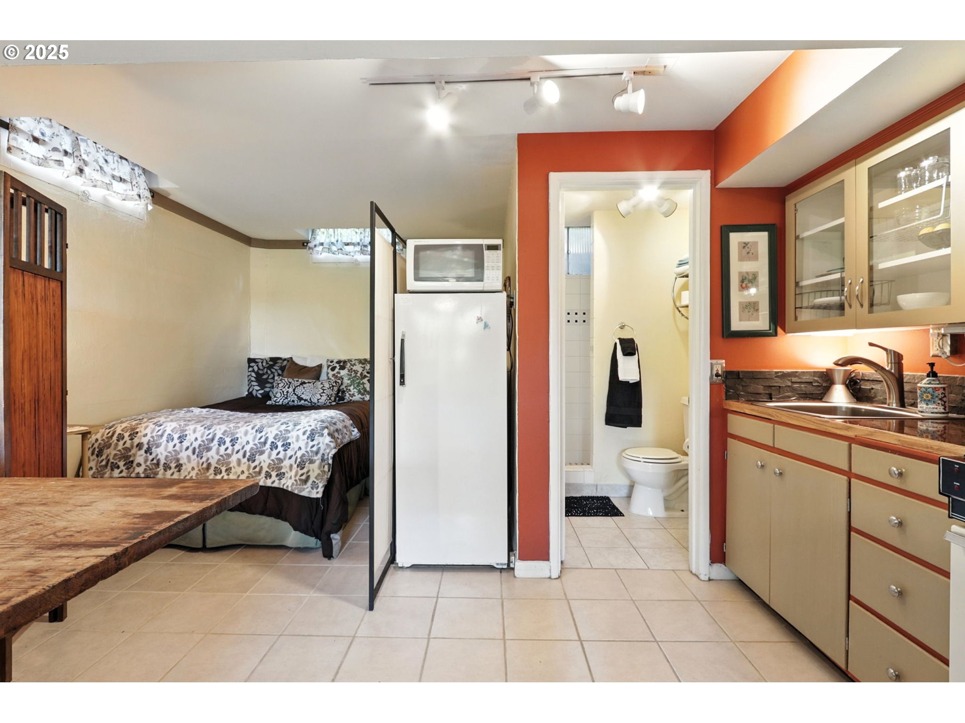7149 Southwest 3rd Avenue Portland, OR 97219 - Photo 24 of 42 a bedroom with a bed and a view of bathroom