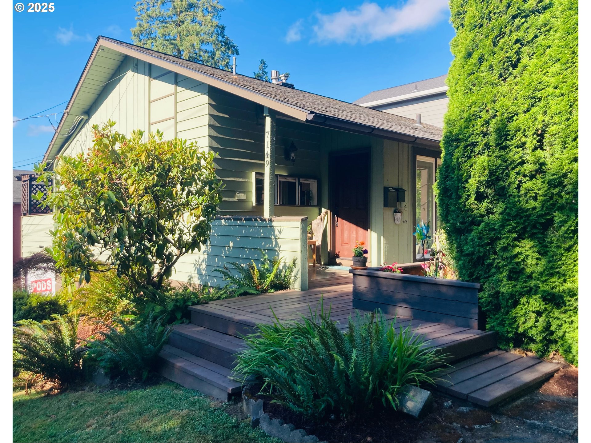 7149 Southwest 3rd Avenue Portland, OR 97219 - Photo 3 of 42 a front view of a house with garden