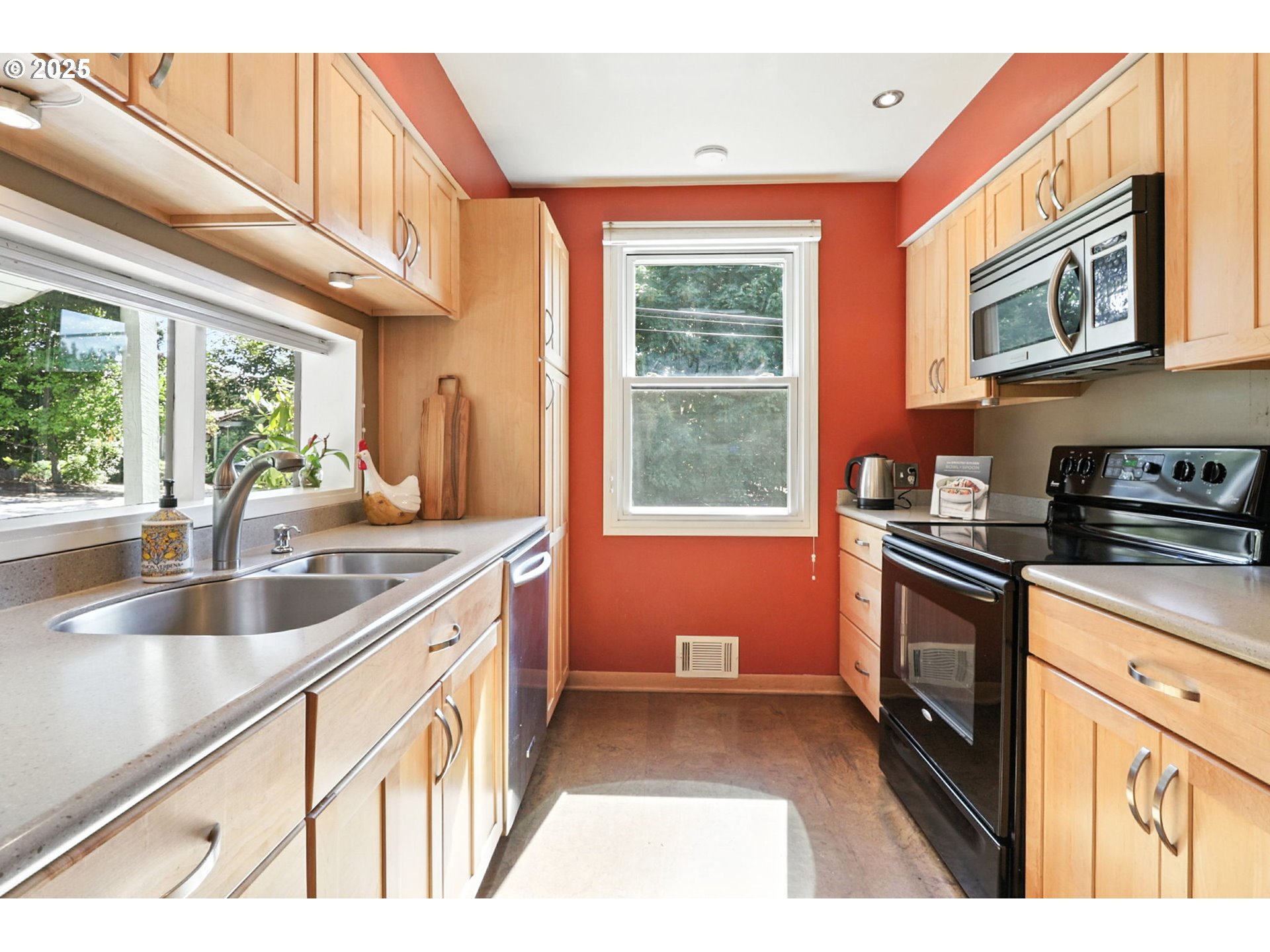 7149 Southwest 3rd Avenue Portland, OR 97219 - Photo 6 of 42 a kitchen with granite countertop a stove a sink and a refrigerator