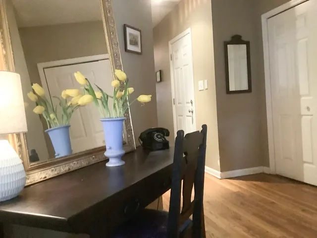 a dining room with furniture and wooden floor