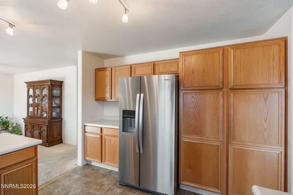 a view of a kitchen with refrigerator and cabinet